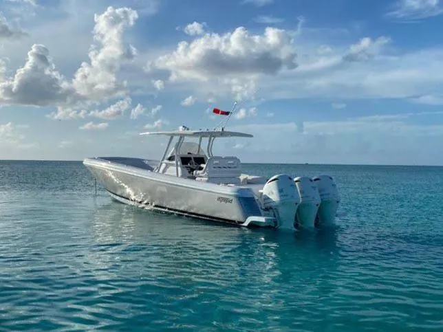 Slide: The Image of 2016 Intrepid 375 Center Console boat on calm ocean waters under a partly cloudy sky. - 27