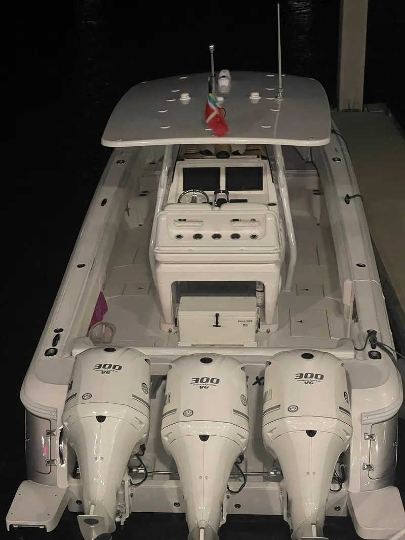 Slide: The Image of 2016 Intrepid 375 Center Console boat with triple 300 horsepower engines docked at night. - 5