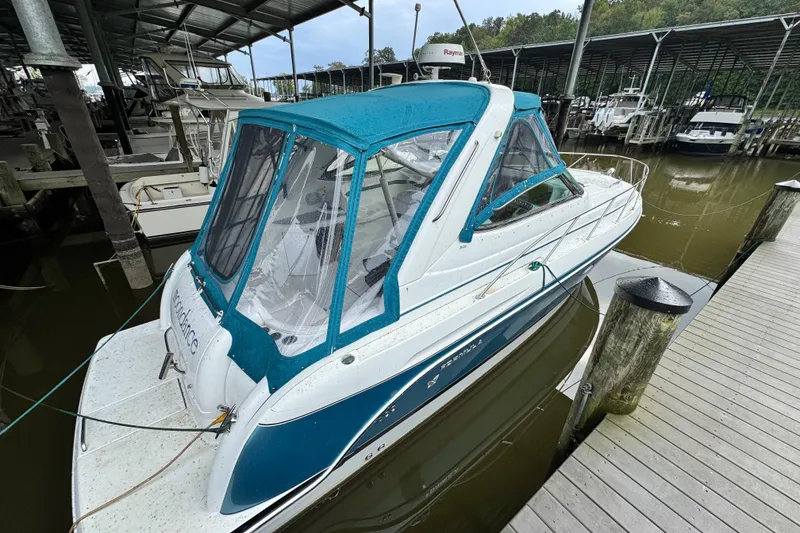 The Image of 2005 Formula 34 Performance Cruiser docked with blue canopy in marina. - 0