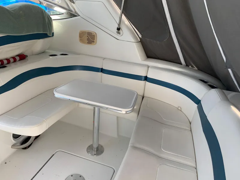 Slide: The Image of 2005 Formula 34 PC boat interior with white and blue seating and table. - 12