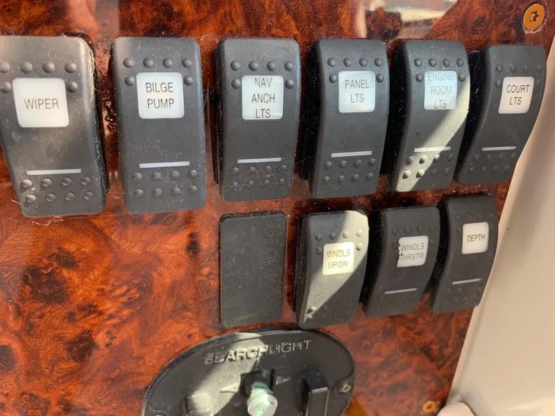Slide: The Image of Control panel of a 2005 Formula 34 Performance Cruiser with labeled switches. - 22