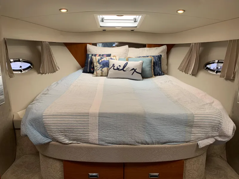 Slide: The Image of Cozy cabin interior of 2005 Formula 34 Performance Cruiser with plush bedding and ambient lighting. - 24