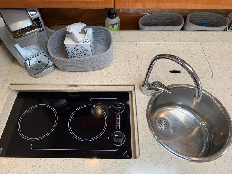 Slide: The Image of 2005 Formula 34 Performance Cruiser kitchen with stove, sink, and countertop accessories. - 29