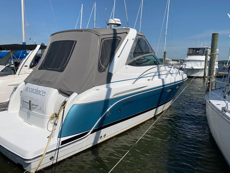 Slide: The Image of Small refrigerator in 2005 Formula 34 Performance Cruiser's wooden interior kitchen area. - 30