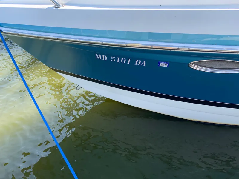 Slide: The Image of 2005 Formula 34 PC boat with registration number MD 5101 DA docked in water. - 7