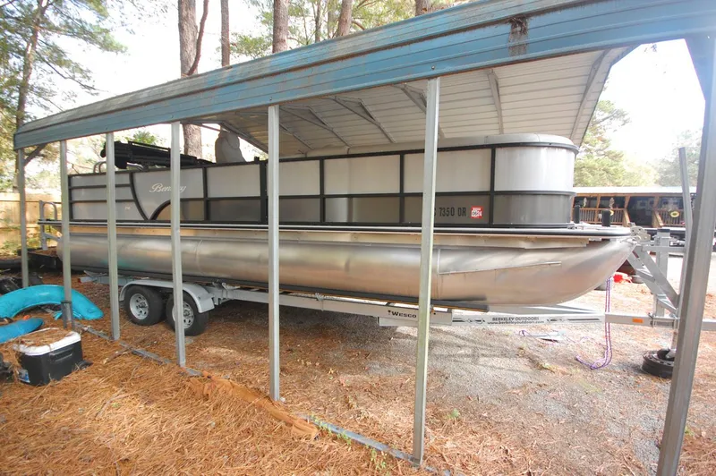The Image of 2021 Bentley Pontoons 243 Swingback under a metal canopy. - 0