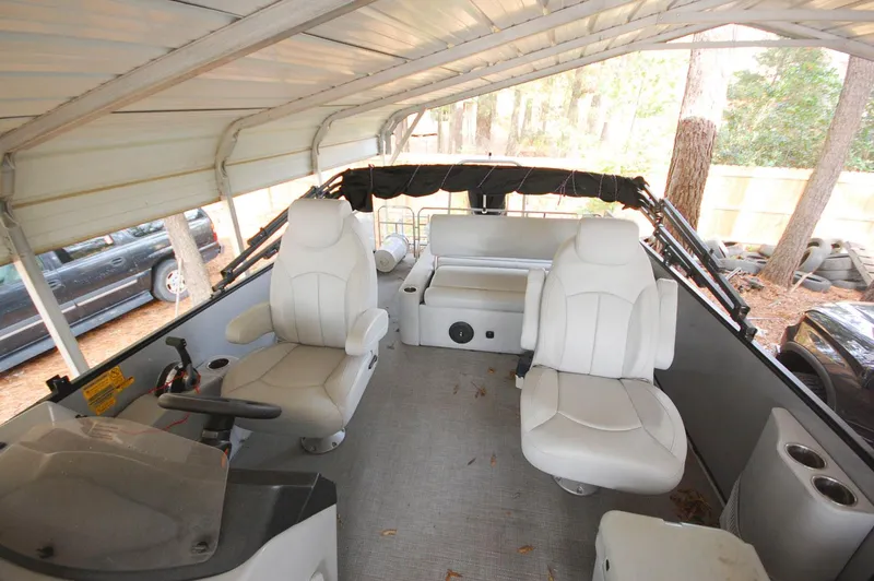 Slide: The Image of 2021 Bentley Pontoons 243 Swingback interior with white seating under a canopy. - 10