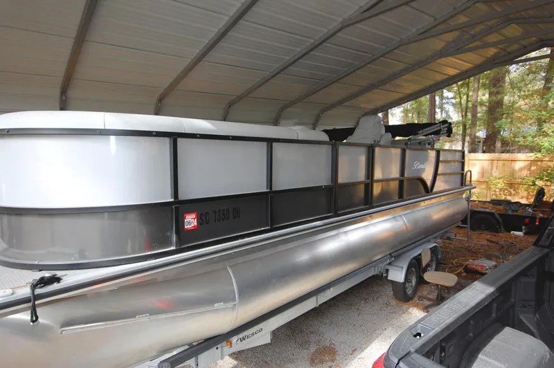 Slide: The Image of 2021 Bentley Pontoons 243 Swingback pontoon boat under a metal canopy. - 14