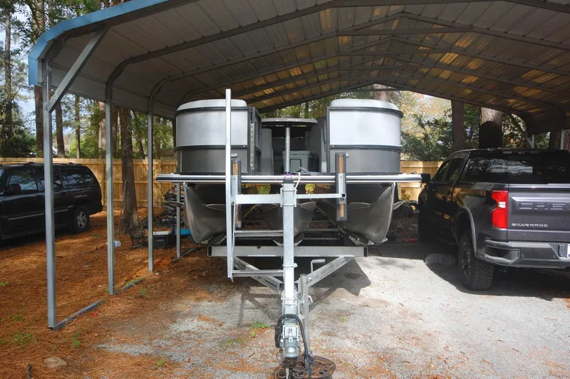 Slide: The Image of 2021 Bentley Pontoons 243 Swingback under a metal carport. - 15