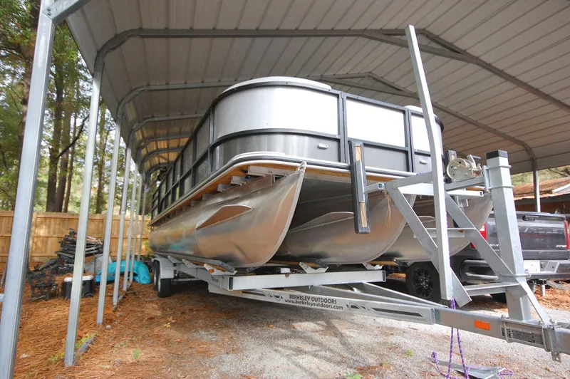 Slide: The Image of 2021 Bentley Pontoons 243 Swingback under a metal canopy. - 3