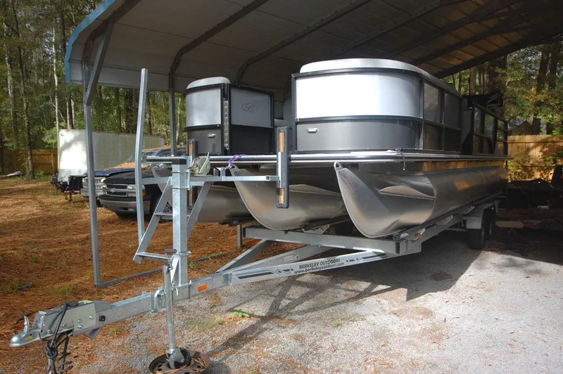 Slide: The Image of 2021 Bentley Pontoons 243 Swingback on trailer under a canopy. - 5