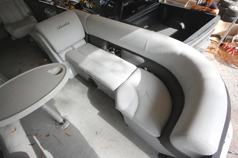 Slide: The Image of 2021 Bentley Pontoons 243 Swingback interior with luxurious seating and table. - 8