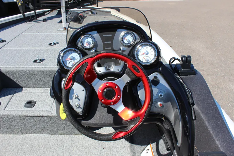 Slide: The Image of 2021 Tracker 195 TXW Tournament Edition boat dashboard with red steering wheel. - 15