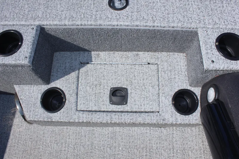 Slide: The Image of 2021 Tracker 195 TXW Tournament Edition boat interior with storage compartments and cup holders. - 17