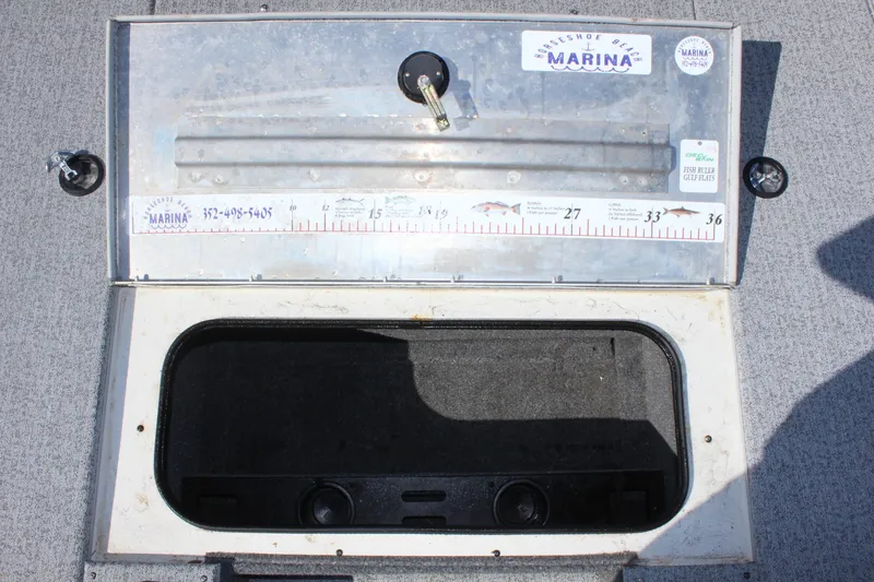Slide: The Image of Open storage compartment of a 2021 Tracker 195 TXW Tournament Edition boat. - 21