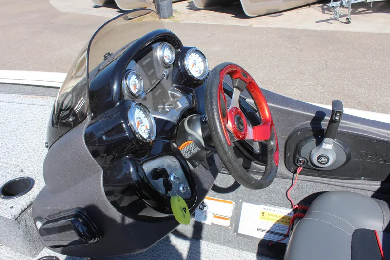 Slide: The Image of 2021 Tracker 195 TXW Tournament Edition boat dashboard with steering wheel and gauges. - 16