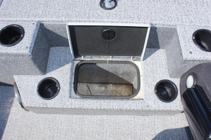 Slide: The Image of 2021 Tracker 195 TXW Tournament Edition boat storage compartment with cup holders. - 18