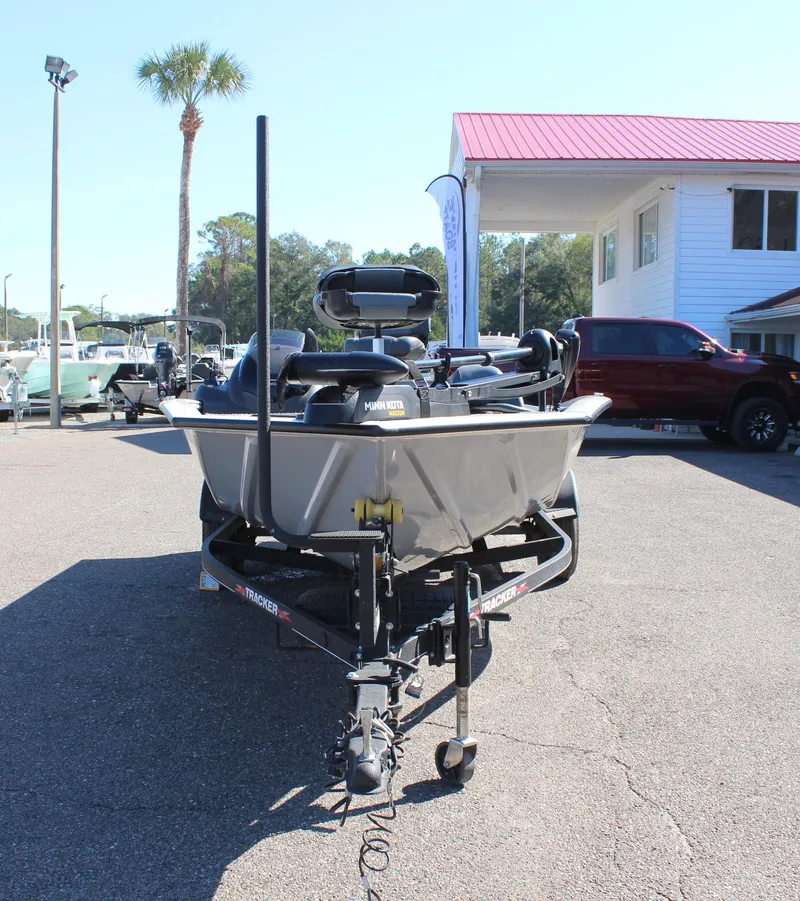 Slide: The Image of 2021 Tracker 195 TXW Tournament Edition boat parked outdoors. - 2