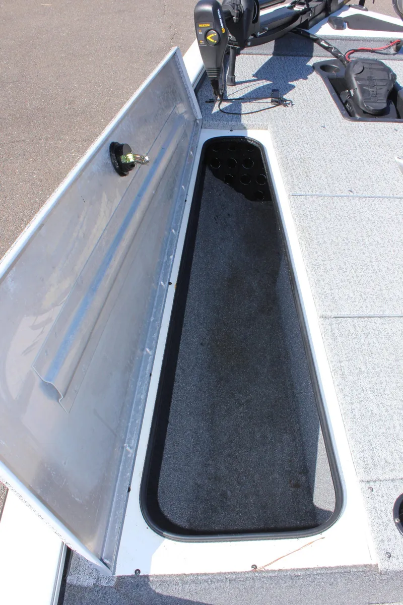 Slide: The Image of 2021 Tracker 195 TXW Tournament Edition boat storage compartment open. - 23