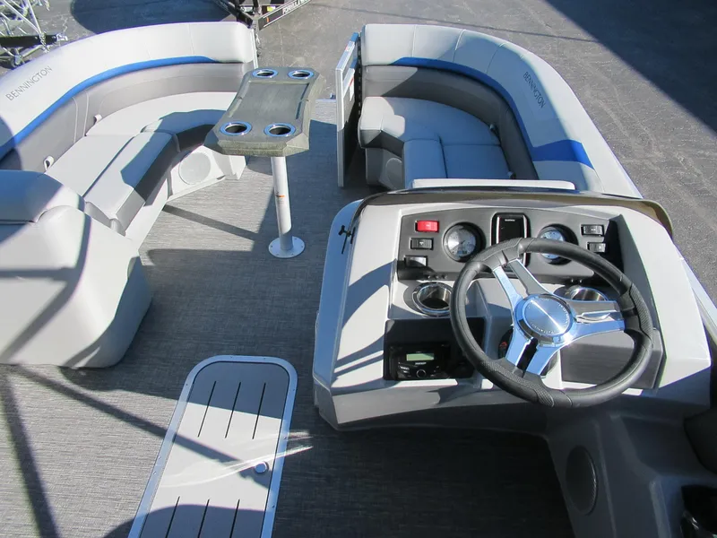 Slide: The Image of 2024 Bennington 22 SXSR pontoon boat interior with helm, seating, and table. - 5