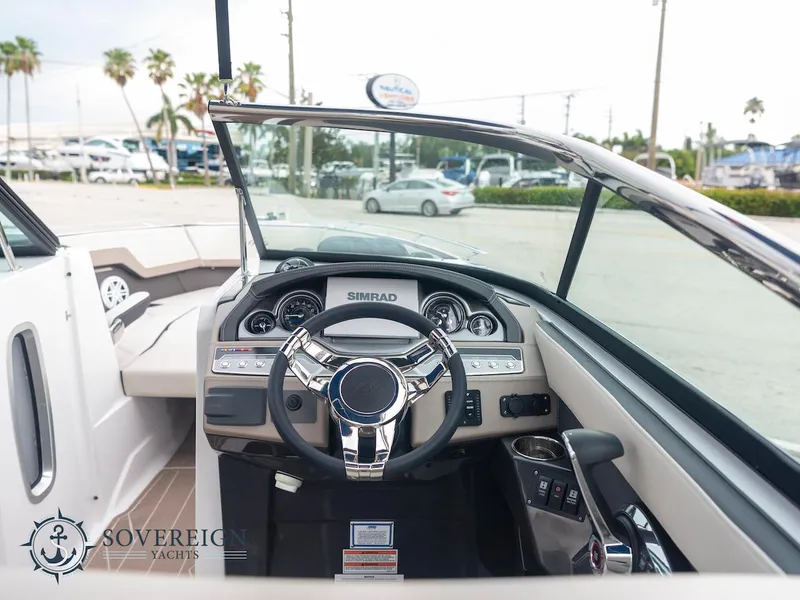 Slide: The Image of 2024 Monterey 275 Super Sport boat cockpit with steering wheel and dashboard. - 13