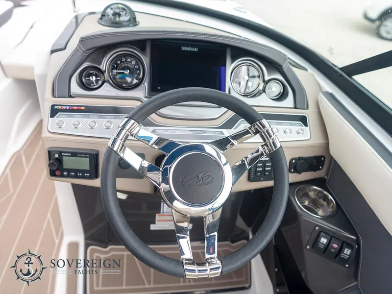 Slide: The Image of 2024 Monterey 275 Super Sport boat dashboard with steering wheel and control panel. - 14