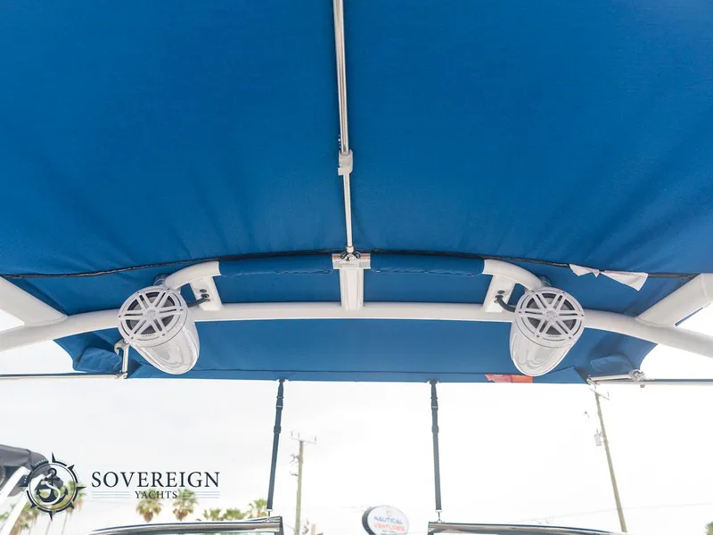 Slide: The Image of 2024 Monterey 275 Super Sport boat with blue canopy and speakers. - 19