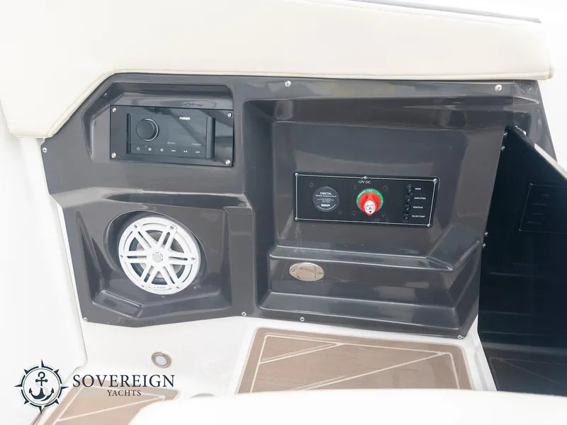 Slide: The Image of 2024 Monterey 275 Super Sport control panel with stereo and speaker, Sovereign Yachts logo. - 21