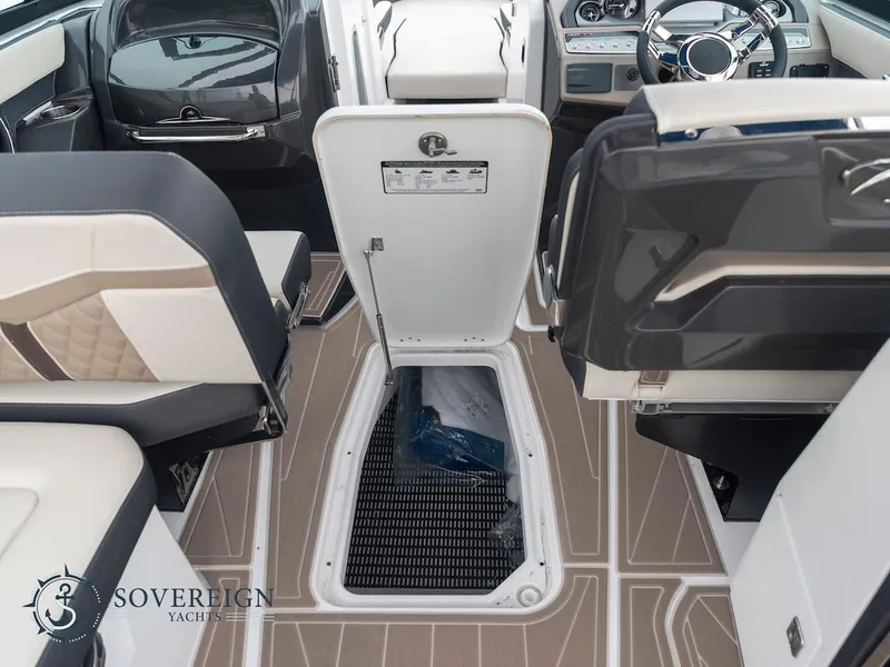 Slide: The Image of 2024 Monterey 275 Super Sport boat interior with open storage compartment. - 24