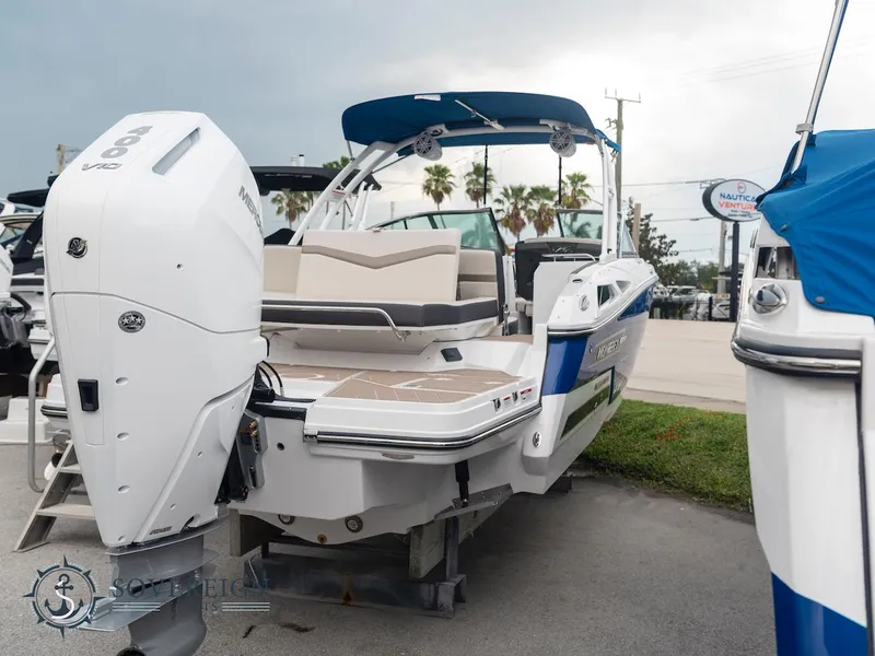 Slide: The Image of 2024 Monterey 275 Super Sport boat with outboard motor, docked on pavement. - 3