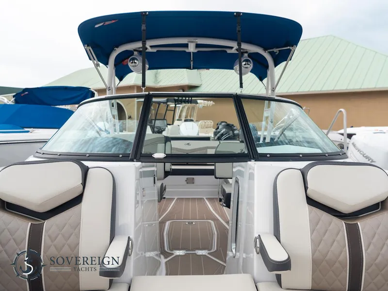 Slide: The Image of 2024 Monterey 275 Super Sport boat interior with blue canopy and luxury seating. - 7