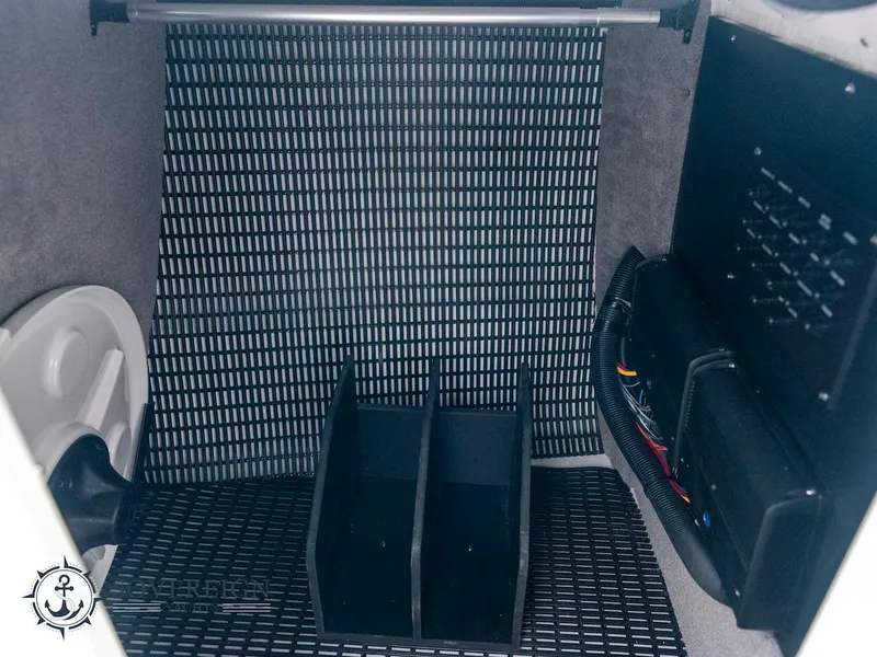 Slide: The Image of 2024 Monterey 275 Super Sport interior storage compartment with organized wiring. - 8