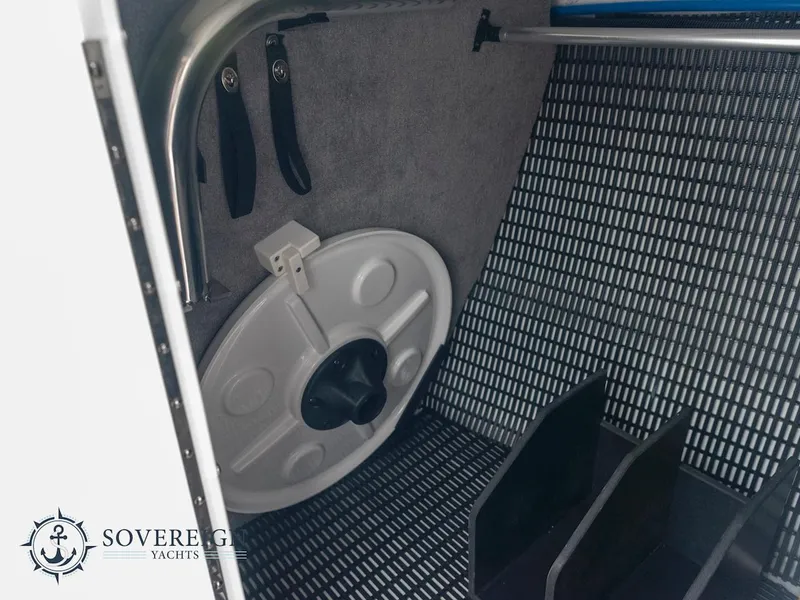 Slide: The Image of 2024 Monterey 275 Super Sport storage compartment with tools and equipment. Sovereign Yachts logo visible. - 9
