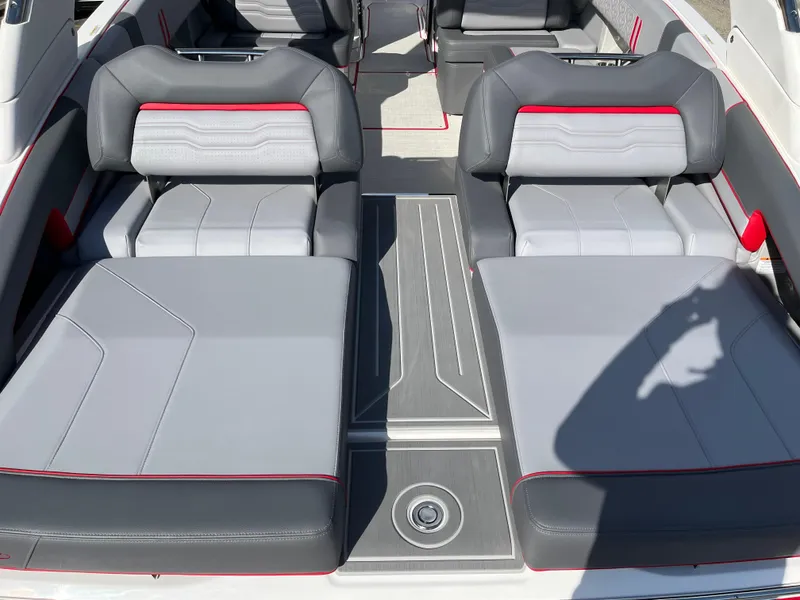 Slide: The Image of 2024 Regal LS9 boat interior with gray and red seating. - 11