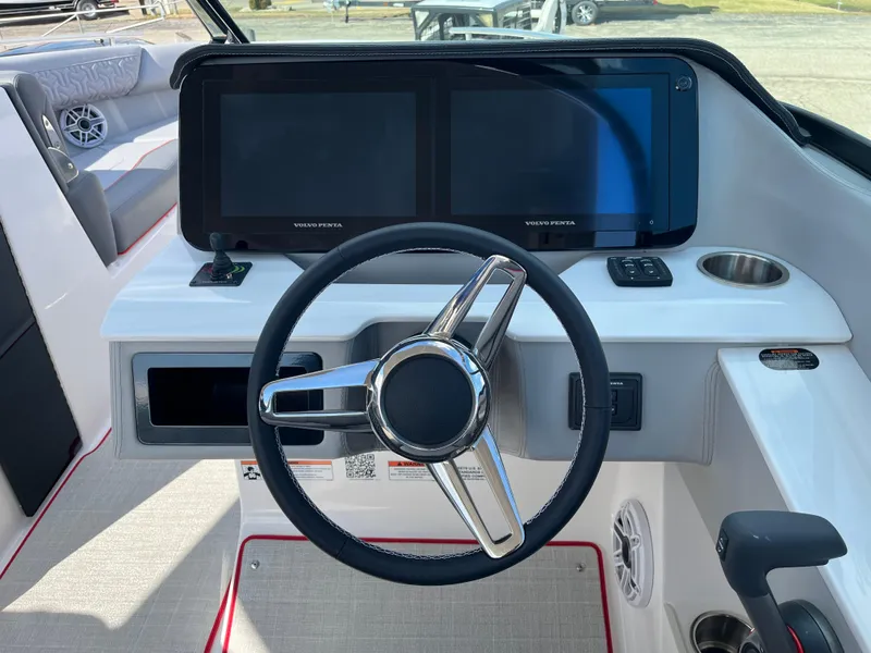 Slide: The Image of 2024 Regal LS9 boat dashboard with dual touchscreen displays and steering wheel. - 5