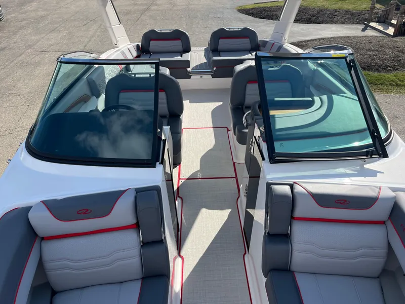 Slide: The Image of 2024 Regal LS9 boat interior with gray and red seating, open windshield. - 8