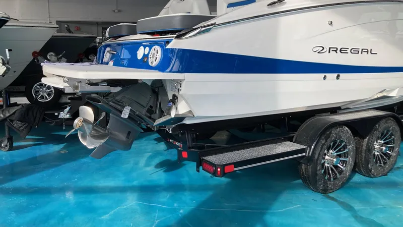 Slide: The Image of 2024 Regal LS6 boat on trailer, rear view in showroom. - 2