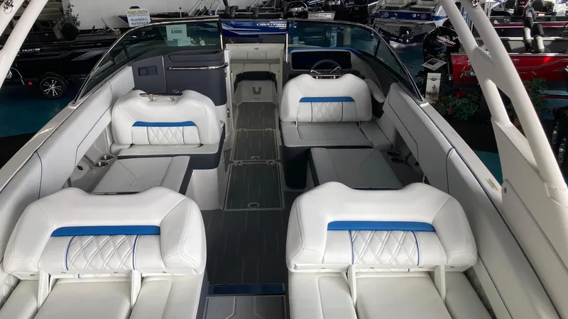Slide: The Image of 2024 Regal LS6 boat interior with white and blue seating, spacious layout. - 3