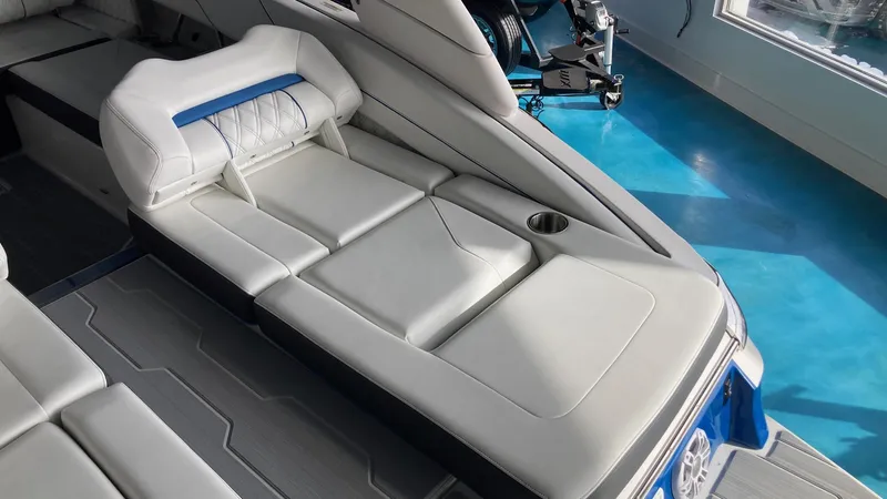Slide: The Image of 2024 Regal LS6 boat interior with white and blue cushioned seating. - 7