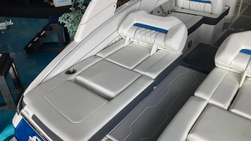 Slide: The Image of 2024 Regal LS6 boat interior with white leather seating and cup holder. - 8