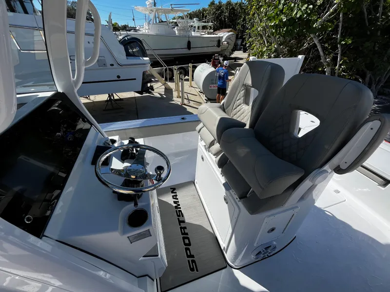 Slide: The Image of 2024 Sportsman Masters 267OE Bay Boat cockpit with dual seats and steering wheel. - 10