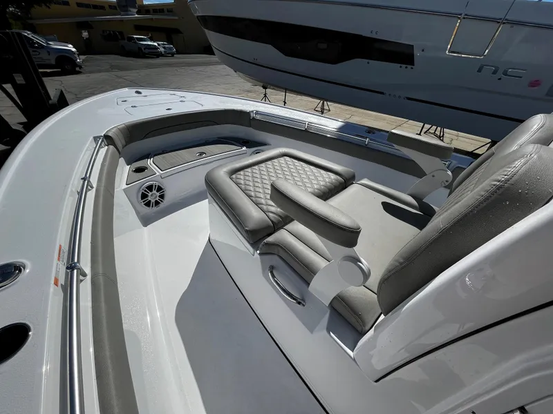 Slide: The Image of 2024 Sportsman Masters 267OE Bay Boat, front seating area with cushioned seats and speaker. - 15