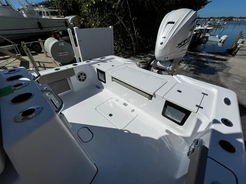 Slide: The Image of 2024 Sportsman Masters 267OE Bay Boat, spacious deck, modern design, docked by the water. - 5