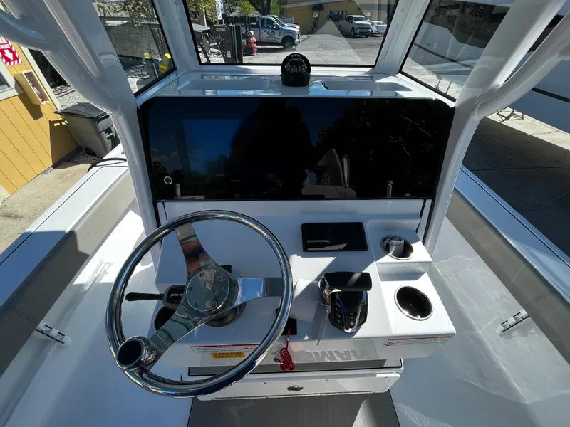 Slide: The Image of 2024 Sportsman Masters 267OE Bay Boat helm with steering wheel and control panel. - 8