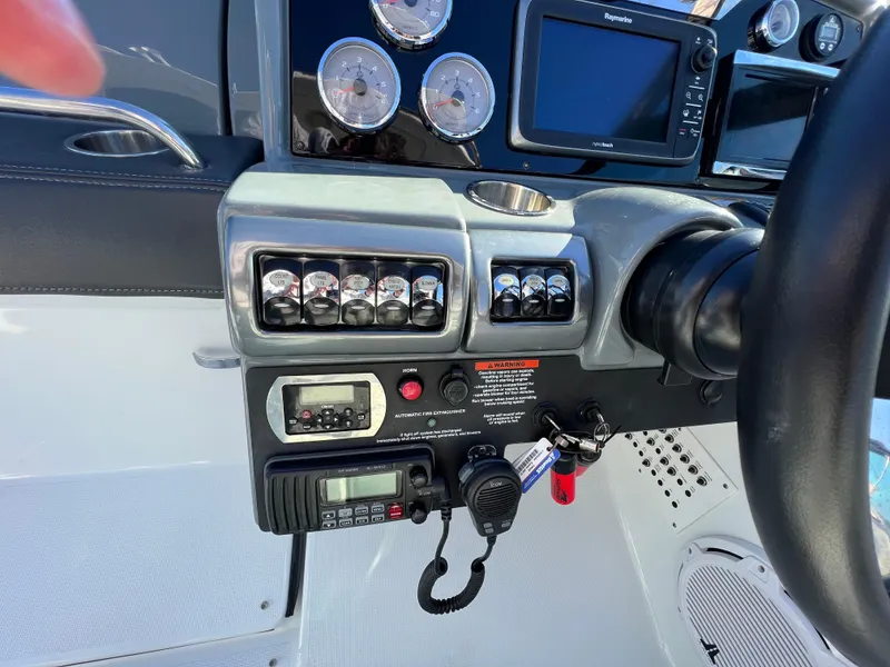Slide: The Image of Control panel of a 2014 Formula 350 Crossover Bowrider boat with gauges and navigation equipment. - 10