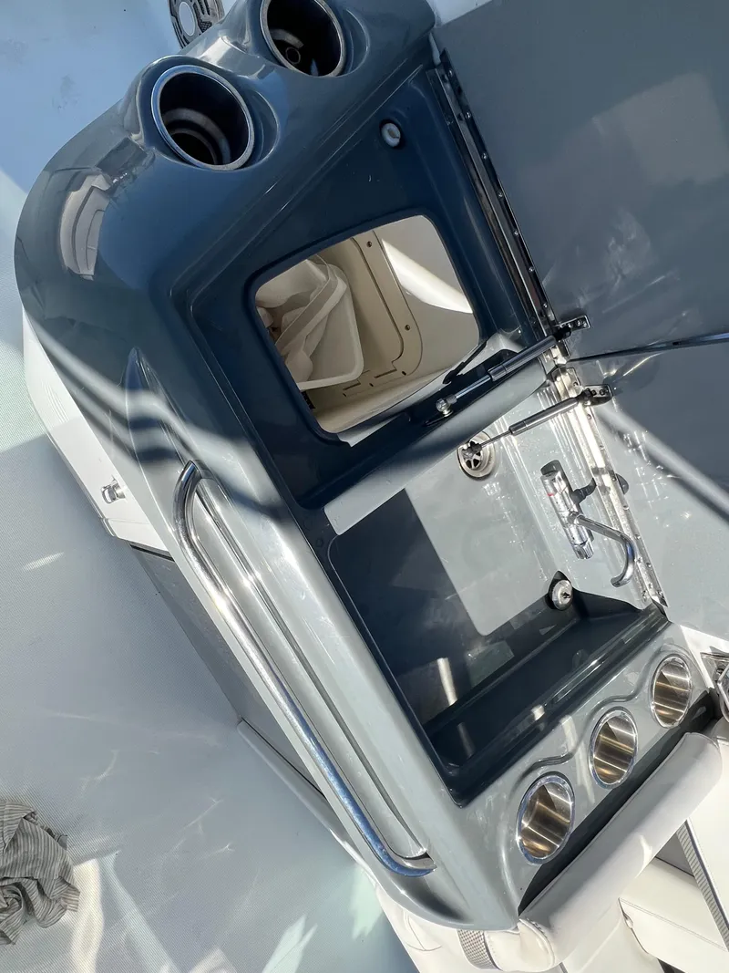 Slide: The Image of 2014 Formula 350 Crossover Bowrider boat interior with sink and storage compartments. - 26