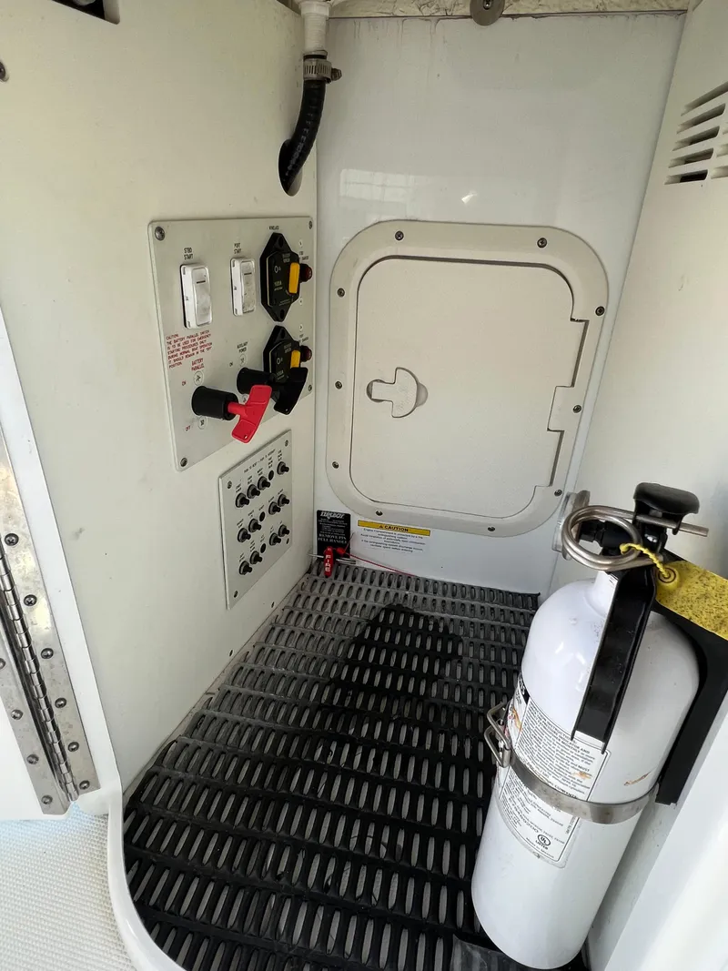 Slide: The Image of 2014 Formula 350 Crossover Bowrider engine room with control panel and fire extinguisher. - 28
