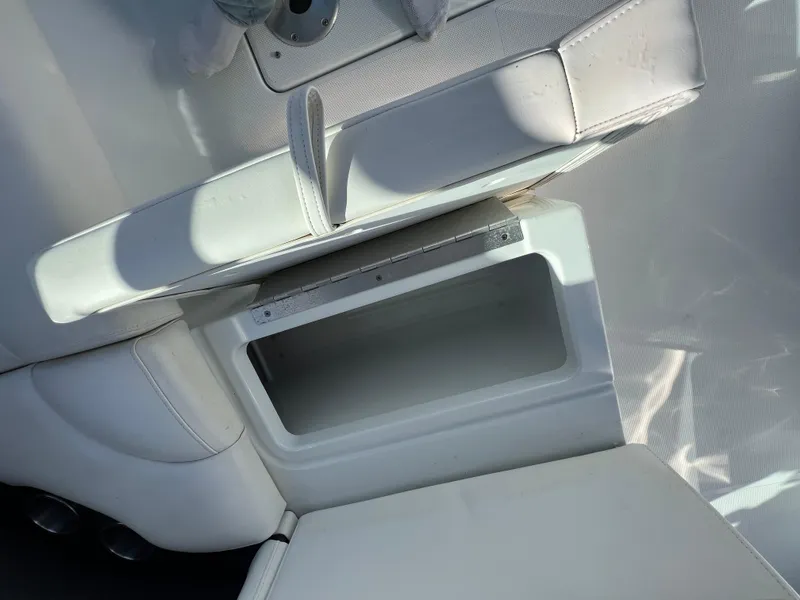 Slide: The Image of 2014 Formula 350 Crossover Bowrider interior storage compartment with white seating. - 30
