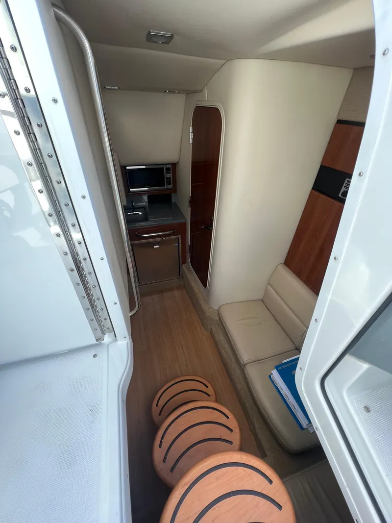 Slide: The Image of 2014 Formula 350 Crossover Bowrider interior cabin with seating and kitchenette. - 36