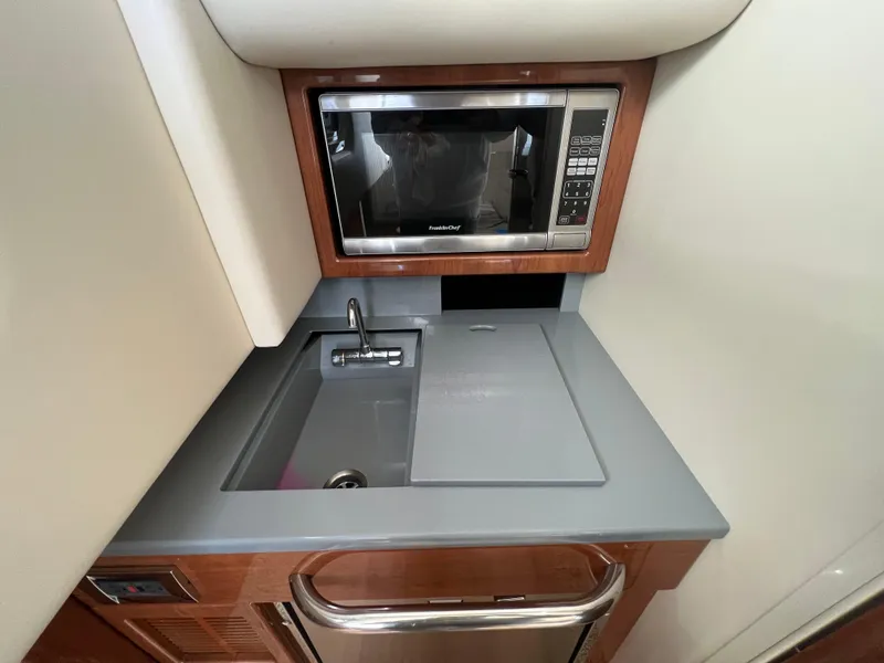 Slide: The Image of Compact kitchenette in 2014 Formula 350 Crossover Bowrider with sink, microwave, and storage. - 45